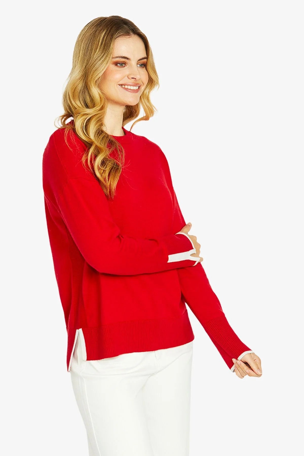 Side profile of red pullover highlighting relaxed fit and almond tipped side splits