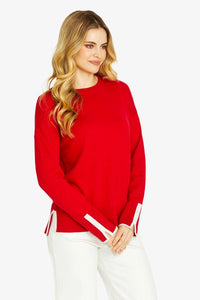 Close-up of smooth fine-gauge red cotton cashmere knit with ribbed hem and cuffs